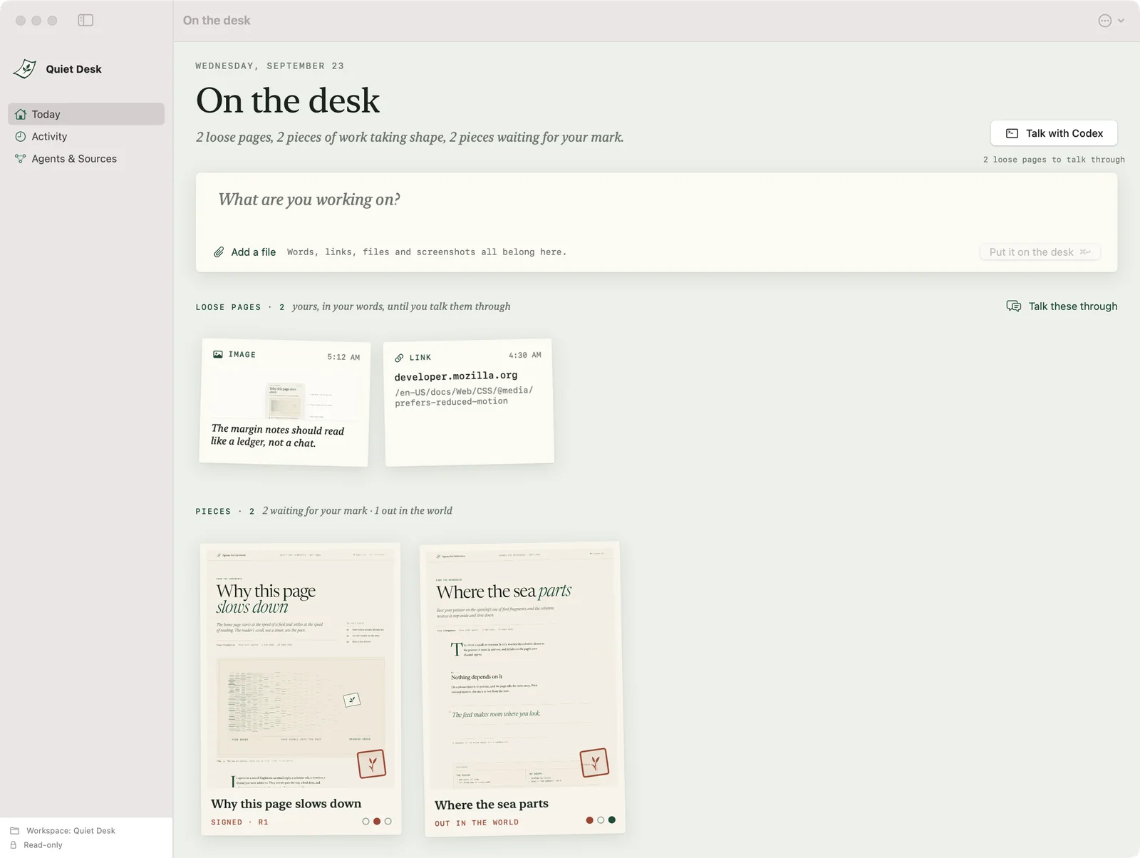 Quiet Desk showing loose pages and pieces on the desk, each signed piece carrying a small red mark.
